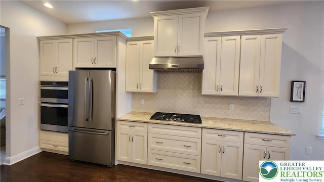 4082 Rutz Ln, South Whitehall Twp, PA 18104 - kitchen with stainless steel appliances, under cabinet range hood, tasteful backsplash, light stone counters, and recessed lighting