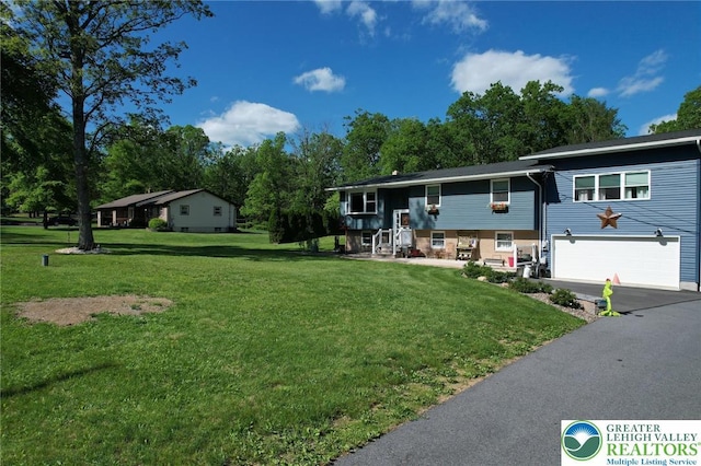 8539 Rextown Rd, Slatington Borough, PA 18080 - view of front facade with an attached garage, driveway, a front lawn, and view of wooded area