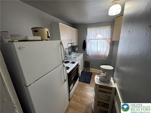 321 W Broad St, Tamaqua Borough, PA 18252 - kitchen with white appliances, light wood-type flooring, and baseboards