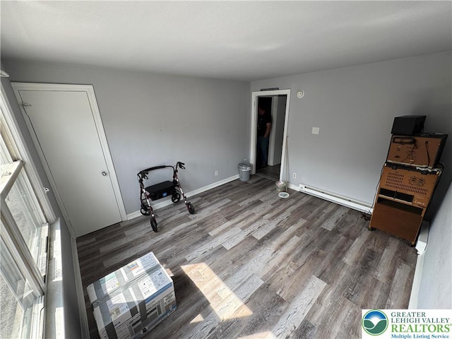 321 W Broad St, Tamaqua Borough, PA 18252 - empty room with a baseboard heating unit, wood finished floors, and baseboards