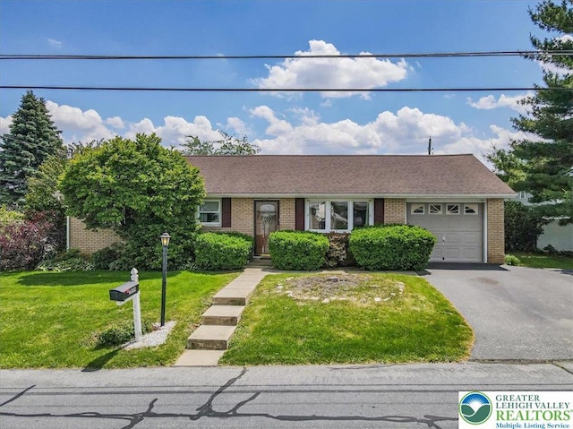 2934 Keystone St, Bethlehem Twp, PA 18020 - view of front facade with an attached garage, brick siding, driveway, and a front lawn