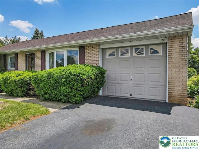 2934 Keystone St, Bethlehem Twp, PA 18020 - view of front of house featuring brick siding, a garage, driveway, and a shingled roof