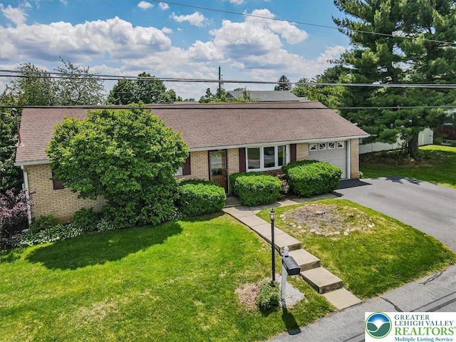 2934 Keystone St, Bethlehem Twp, PA 18020 - view of front of house with asphalt driveway, brick siding, a front yard, and a garage