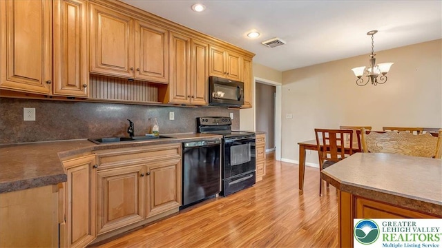 2934 Keystone St, Bethlehem Twp, PA 18020 - kitchen featuring black appliances, a sink, tasteful backsplash, light wood-style floors, and a chandelier