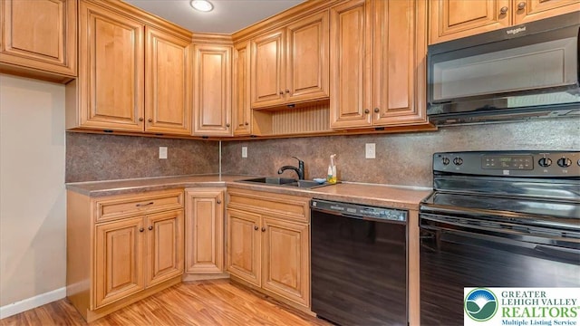 2934 Keystone St, Bethlehem Twp, PA 18020 - kitchen with black appliances, a sink, light wood finished floors, backsplash, and baseboards