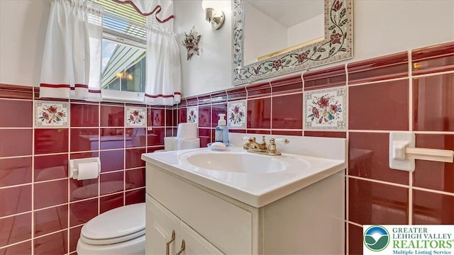 2934 Keystone St, Bethlehem Twp, PA 18020 - bathroom with tile walls, vanity, toilet, and a wainscoted wall