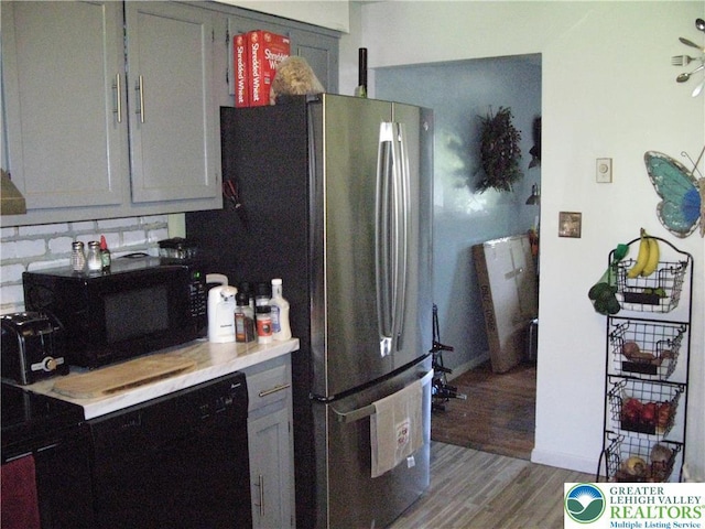 1158 Driver Pl, Lower Macungie Twp, PA 18106 - kitchen featuring light countertops, black microwave, light wood-style floors, baseboards, and backsplash