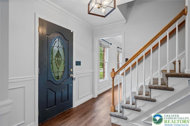 5753 Shady Ln, Plainfield Twp, PA 18064 - foyer with ornamental molding, stairway, dark wood finished floors, a decorative wall, and wainscoting