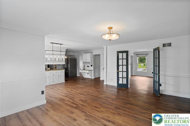 5753 Shady Ln, Plainfield Twp, PA 18064 - unfurnished living room with ornamental molding, dark wood-type flooring, and baseboards