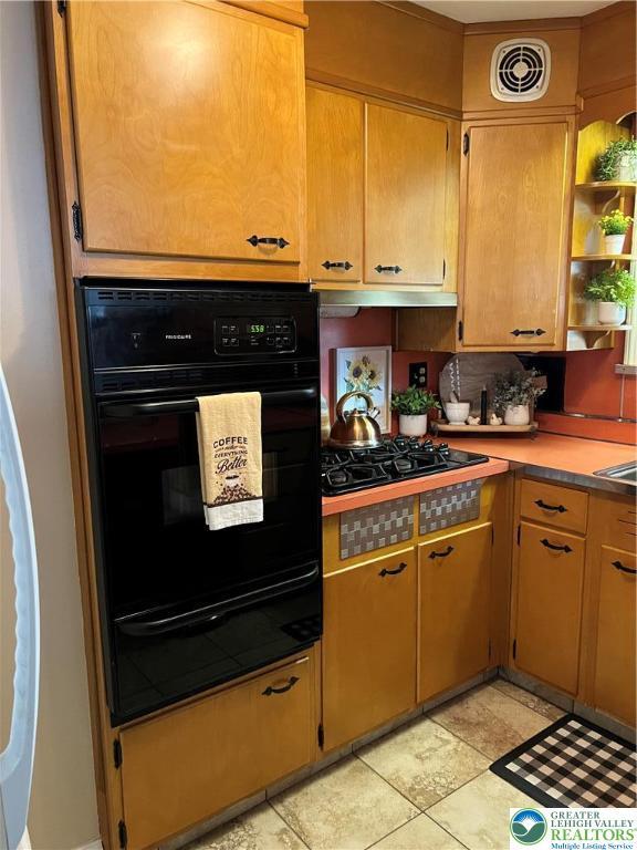 1540 Riegel St, Hellertown Borough, PA 18055 - kitchen with a warming drawer, black appliances, open shelves, under cabinet range hood, and light countertops