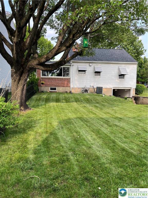 1540 Riegel St, Hellertown Borough, PA 18055 - rear view of house with cooling unit and a lawn