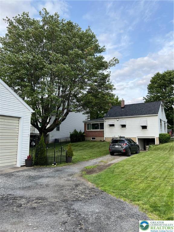 1540 Riegel St, Hellertown Borough, PA 18055 - view of front facade featuring a chimney and asphalt driveway
