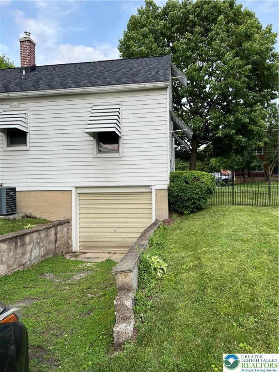 1540 Riegel St, Hellertown Borough, PA 18055 - view of side of home with central air condition unit, a chimney, and roof with shingles
