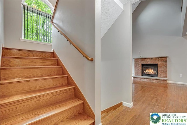 2330 Burntwood Dr, East Stroudsburg, PA 18301 - stairway with wood-type flooring and a brick fireplace