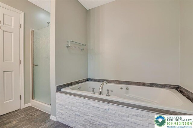 2330 Burntwood Dr, East Stroudsburg, PA 18301 - bathroom with a bath, a shower stall, and wood finished floors