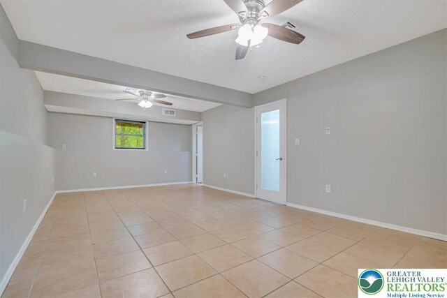 2330 Burntwood Dr, East Stroudsburg, PA 18301 - spare room featuring ceiling fan, light tile patterned flooring, and a textured ceiling