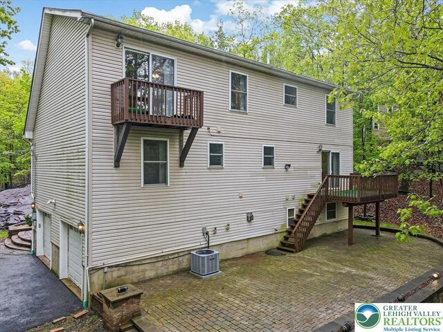 2330 Burntwood Dr, East Stroudsburg, PA 18301 - rear view of house featuring stairway, a patio, a wooden deck, and a garage