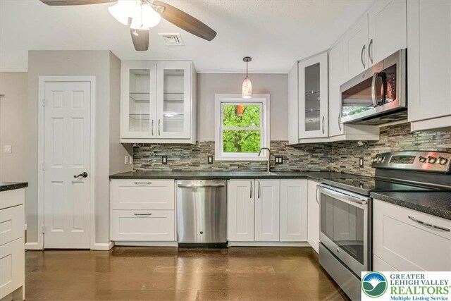 2330 Burntwood Dr, East Stroudsburg, PA 18301 - kitchen with appliances with stainless steel finishes, decorative backsplash, and white cabinets