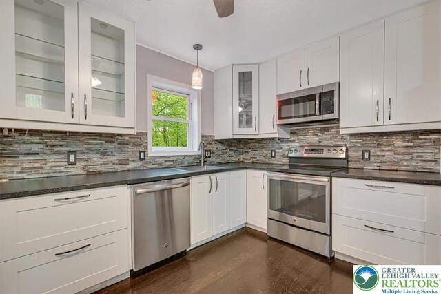 2330 Burntwood Dr, East Stroudsburg, PA 18301 - kitchen with stainless steel appliances, white cabinetry, and decorative backsplash