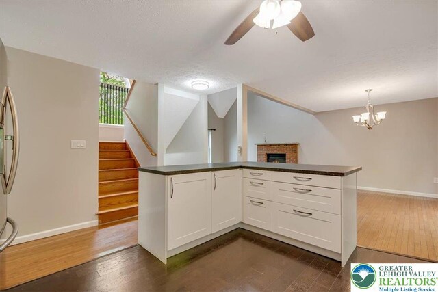 2330 Burntwood Dr, East Stroudsburg, PA 18301 - kitchen featuring dark wood-style floors, dark countertops, and white cabinetry