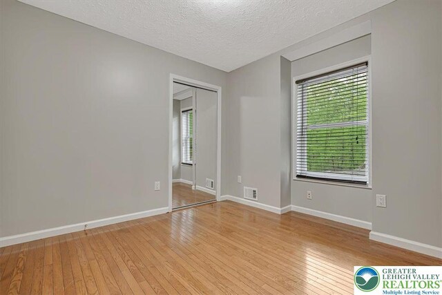 2330 Burntwood Dr, East Stroudsburg, PA 18301 - spare room featuring light wood-type flooring and a textured ceiling