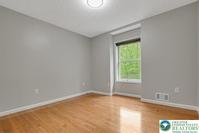 2330 Burntwood Dr, East Stroudsburg, PA 18301 - spare room featuring light wood-style flooring and a textured ceiling