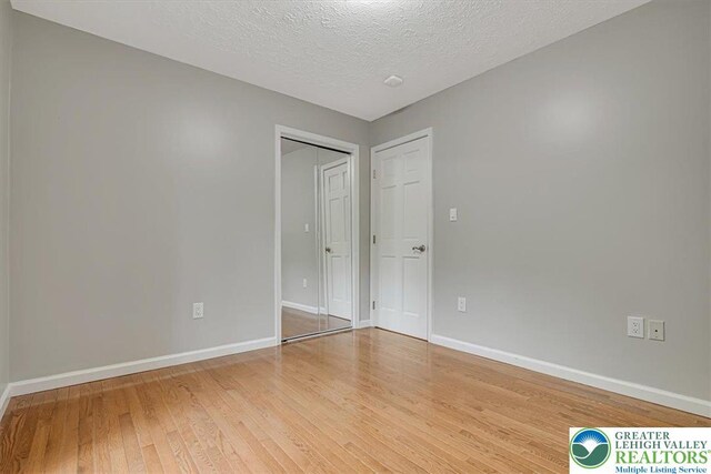 2330 Burntwood Dr, East Stroudsburg, PA 18301 - spare room featuring light wood-type flooring and a textured ceiling