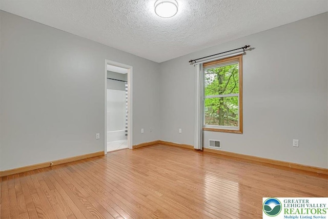 2330 Burntwood Dr, East Stroudsburg, PA 18301 - spare room featuring light wood-style floors and a textured ceiling