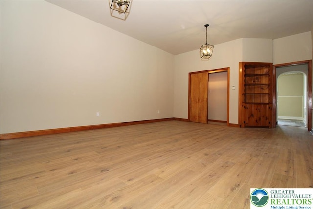 1171 E 4th St, Bethlehem City, PA 18015 - empty room featuring light wood-style floors, baseboards, a chandelier, and arched walkways