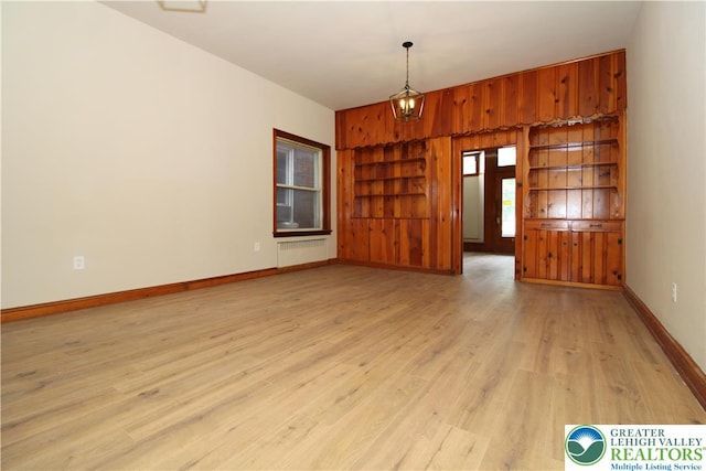 1171 E 4th St, Bethlehem City, PA 18015 - empty room with radiator, light wood finished floors, baseboards, and built in shelves