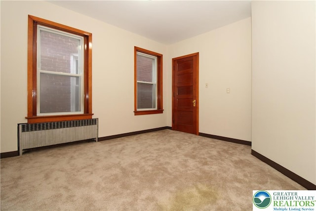 1171 E 4th St, Bethlehem City, PA 18015 - empty room featuring radiator heating unit, carpet flooring, and baseboards