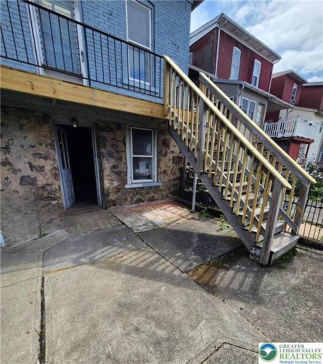 1171 E 4th St, Bethlehem City, PA 18015 - view of exterior entry with brick siding, stone siding, and a patio