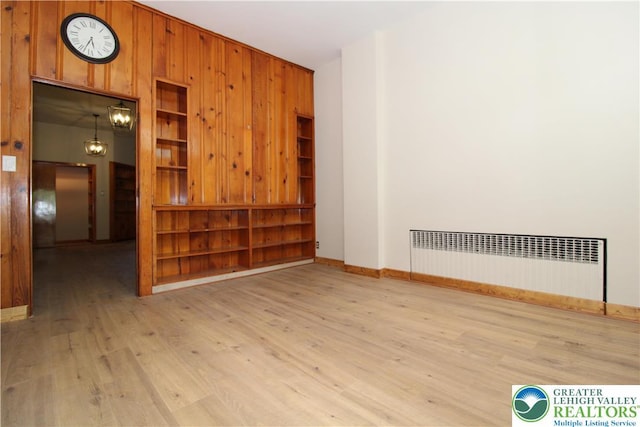 1171 E 4th St, Bethlehem City, PA 18015 - empty room featuring radiator, wood finished floors, wooden walls, and baseboards