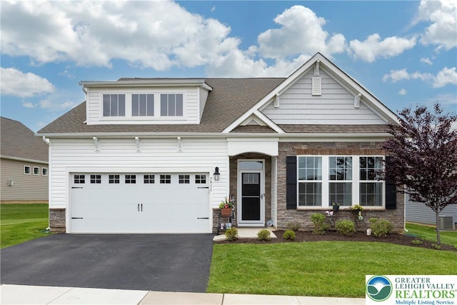 7911 Schaefer Crst, Upper Macungie Twp, PA 18031 - view of front of home featuring asphalt driveway, a front lawn, roof with shingles, and stone siding