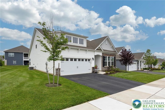 7911 Schaefer Crst, Upper Macungie Twp, PA 18031 - view of front facade with asphalt driveway, central AC, a front lawn, and a garage