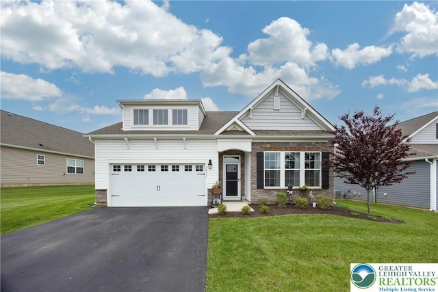 7911 Schaefer Crst, Upper Macungie Twp, PA 18031 - view of front of home featuring driveway, stone siding, a front yard, and roof with shingles