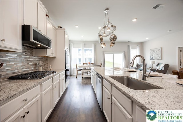7911 Schaefer Crst, Upper Macungie Twp, PA 18031 - kitchen with a sink, stainless steel appliances, backsplash, dark wood-style flooring, and white cabinets