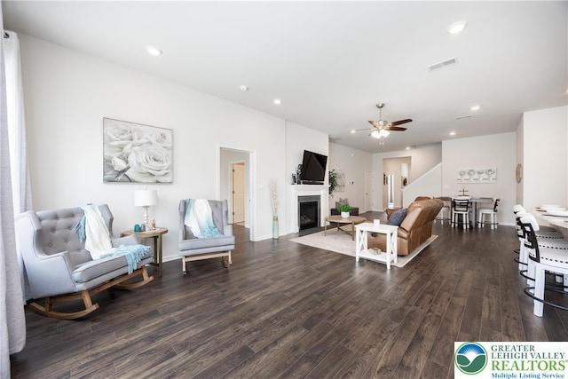 7911 Schaefer Crst, Upper Macungie Twp, PA 18031 - living room with dark wood-style floors, a ceiling fan, a fireplace with flush hearth, recessed lighting, and stairs