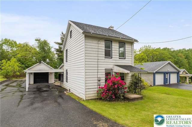 735 Beaver Run Dr, Mahoning Township, PA 18235 - traditional-style house with a garage, a front lawn, a chimney, an outdoor structure, and roof with shingles