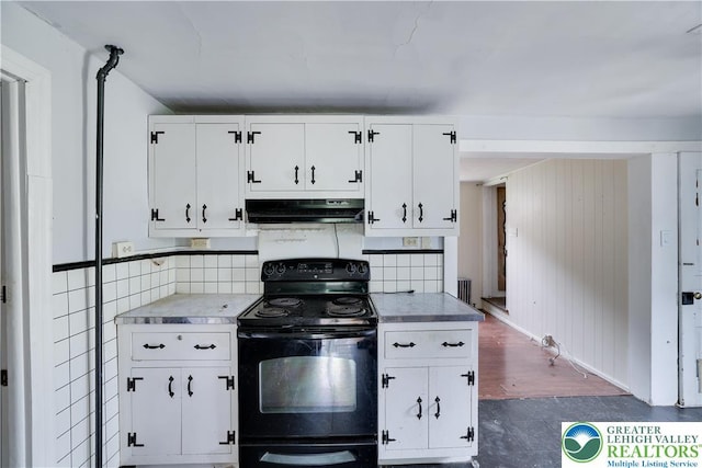 735 Beaver Run Dr, Mahoning Township, PA 18235 - kitchen featuring black range with electric stovetop, under cabinet range hood, white cabinets, light countertops, and dark wood finished floors
