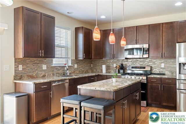 799 Swallow Tail Ln, Upper Macungie Twp, PA 18031 - kitchen featuring appliances with stainless steel finishes, light wood-type flooring, dark brown cabinetry, a kitchen island, and recessed lighting