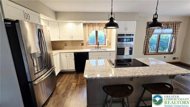 2872 Sheffield Dr, Lower Macungie Twp, PA 18049 - kitchen featuring black appliances, a sink, dark wood-type flooring, decorative backsplash, and a center island