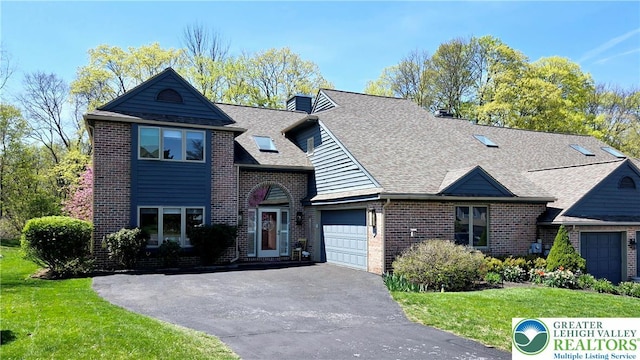 2872 Sheffield Dr, Lower Macungie Twp, PA 18049 - view of front of house with driveway, an attached garage, brick siding, a front yard, and a shingled roof