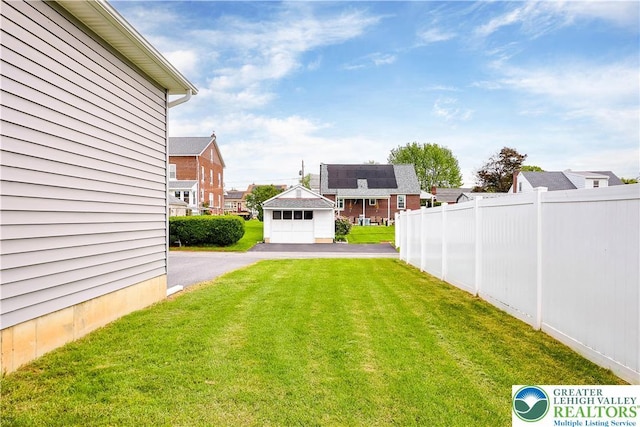 721 7th St, Whitehall Twp, PA 18052 - view of yard featuring asphalt driveway, a garage, and a residential view