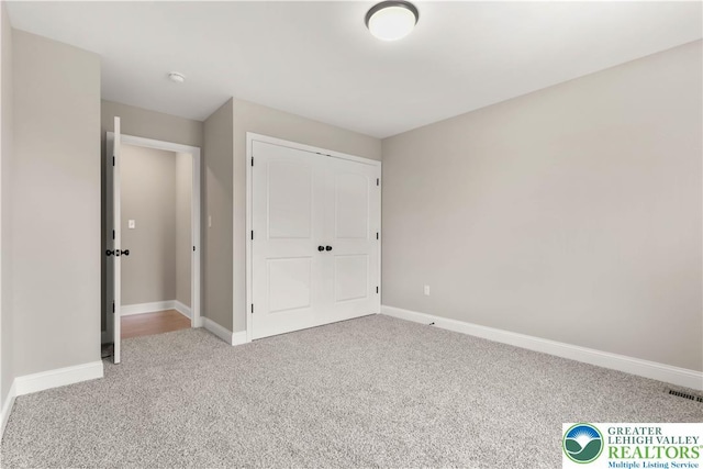 721 7th St, Whitehall Twp, PA 18052 - unfurnished bedroom with light colored carpet, baseboards, and a closet