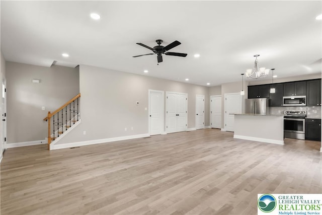 721 7th St, Whitehall Twp, PA 18052 - unfurnished living room featuring a chandelier, baseboards, recessed lighting, stairs, and ceiling fan