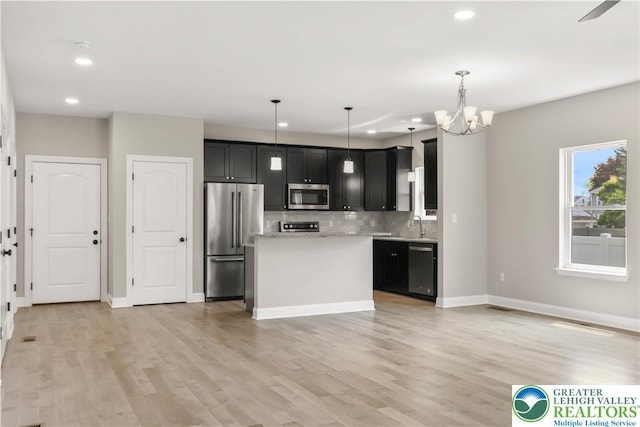 721 7th St, Whitehall Twp, PA 18052 - kitchen featuring appliances with stainless steel finishes, light countertops, backsplash, recessed lighting, and a chandelier
