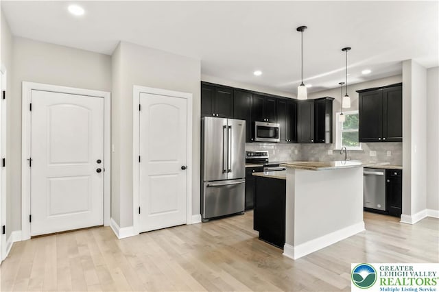 721 7th St, Whitehall Twp, PA 18052 - kitchen featuring appliances with stainless steel finishes, dark cabinetry, light wood-style floors, tasteful backsplash, and recessed lighting