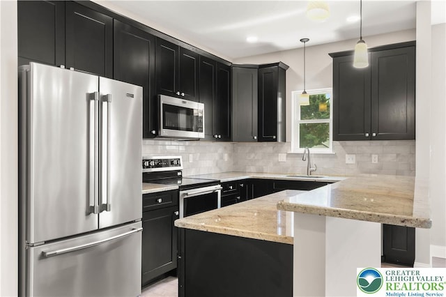 721 7th St, Whitehall Twp, PA 18052 - kitchen with stainless steel appliances, dark cabinets, a sink, light stone countertops, and recessed lighting