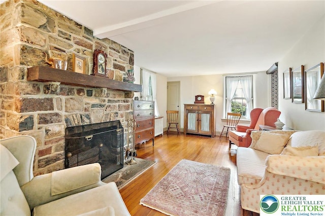 1132 Upperstump Rd, Hilltown Twp, PA 18914 - living room with beam ceiling, wood finished floors, and a fireplace